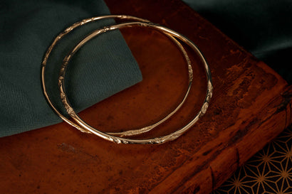 underwater river solid gold bangle patternated to look worn by water