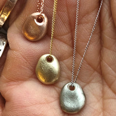 Solid gold pebble necklace with a diamond,  cast from a tiny real English pebble.