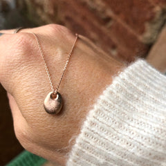 Solid gold pebble necklace cast from a tiny real English pebble. Lovely gold Nugget pendantSolid gold pebble necklace cast from a tiny real English pebble.